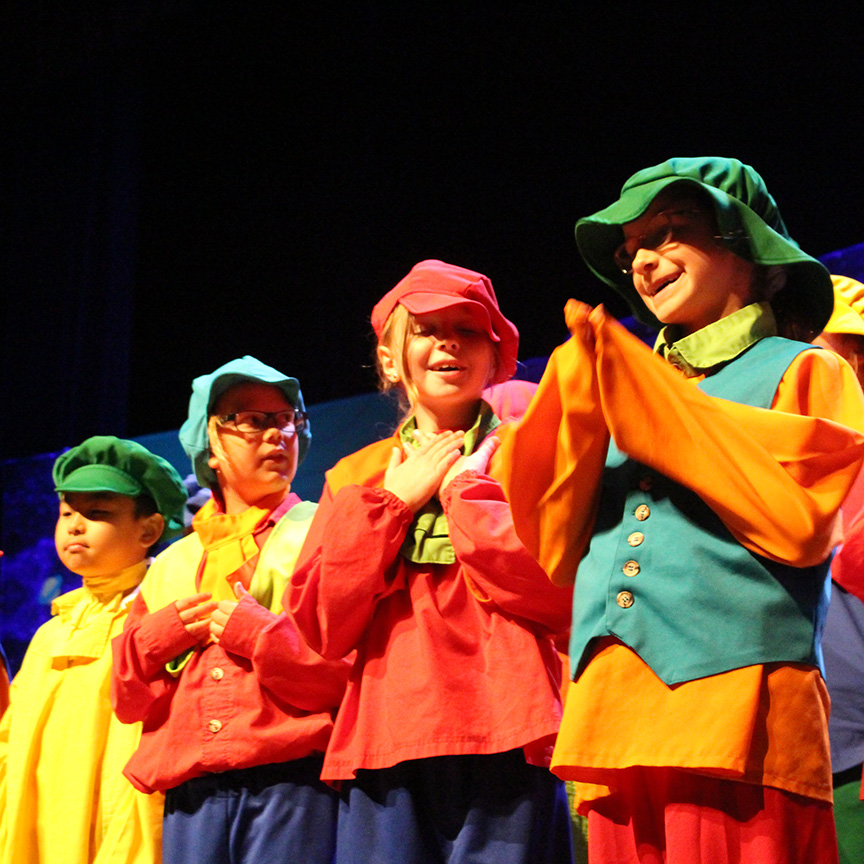 Campers in colorful outfits perform in the final show