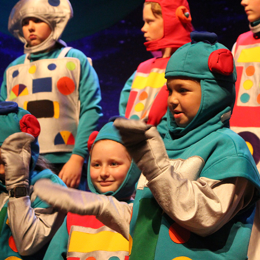 A camper in a colorful astronaut costume performs in the final show