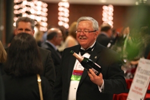 Jack Keegan pours wine for attendees
