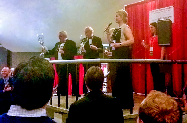 Attendees toasting to Jack Keegan and Gil Gordon