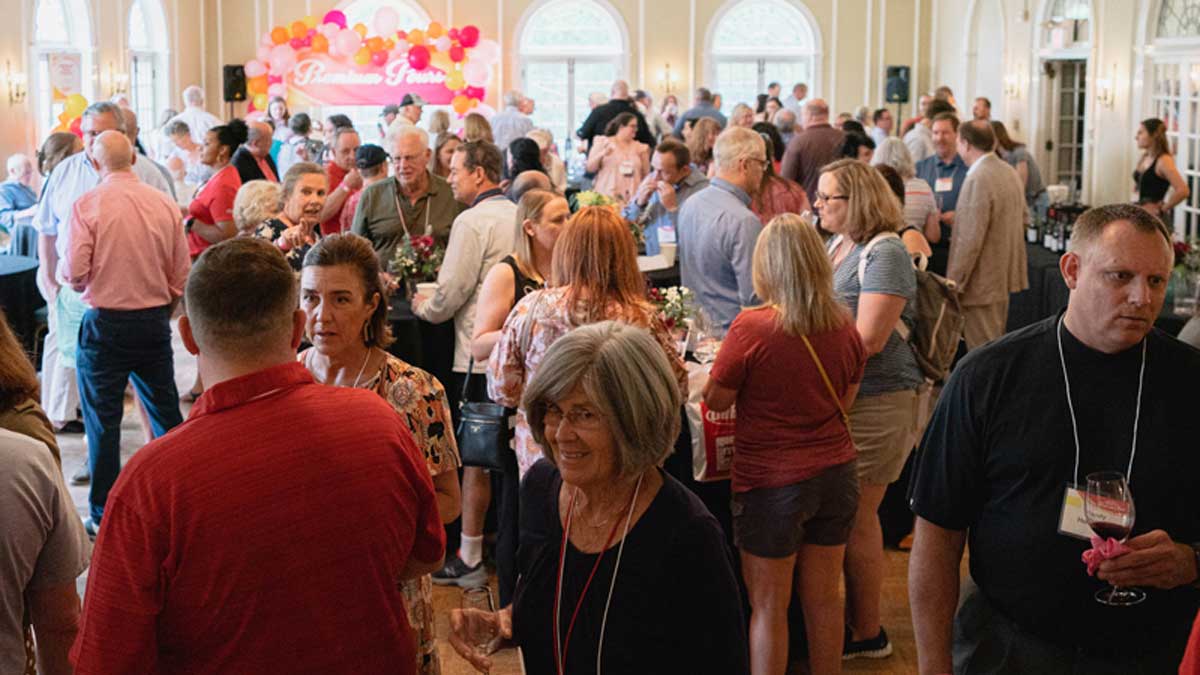  wide shot of the venue ballroom filled with people mingling 