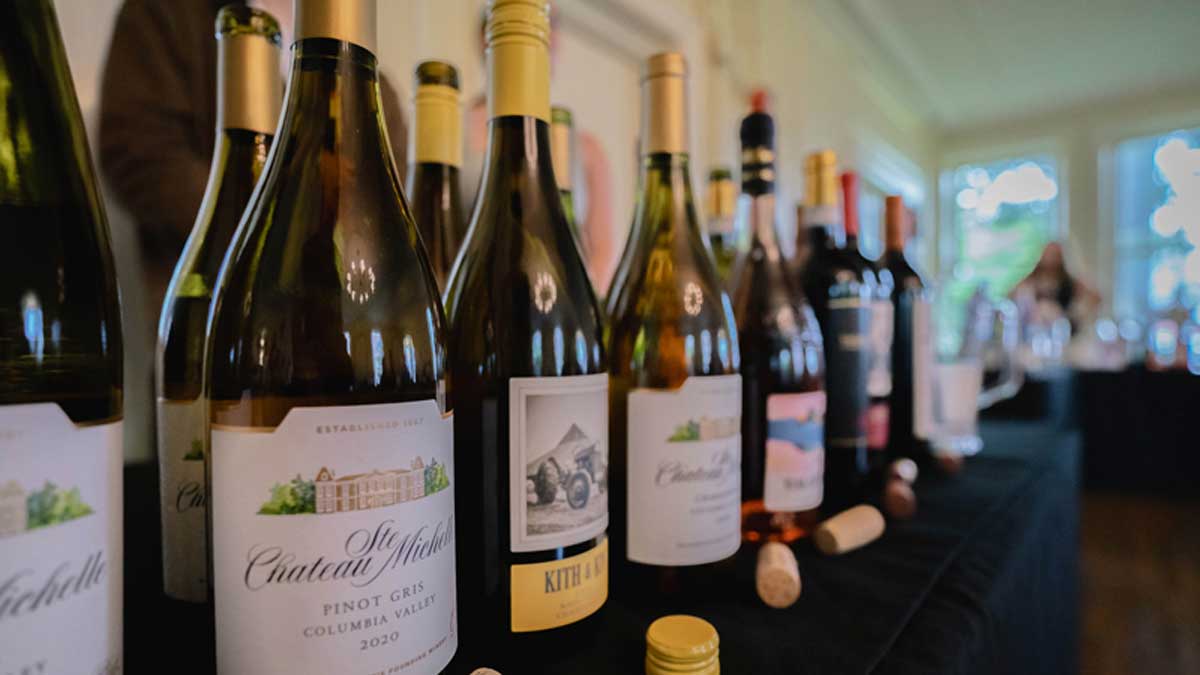  Several wines ready for tasting line the tables of the Arts Center