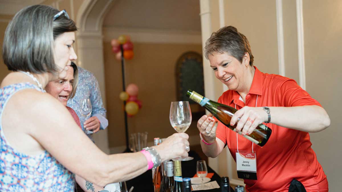  PAS Advisory Board President Sabrina Jewell holds out her glass for a sample of wine
