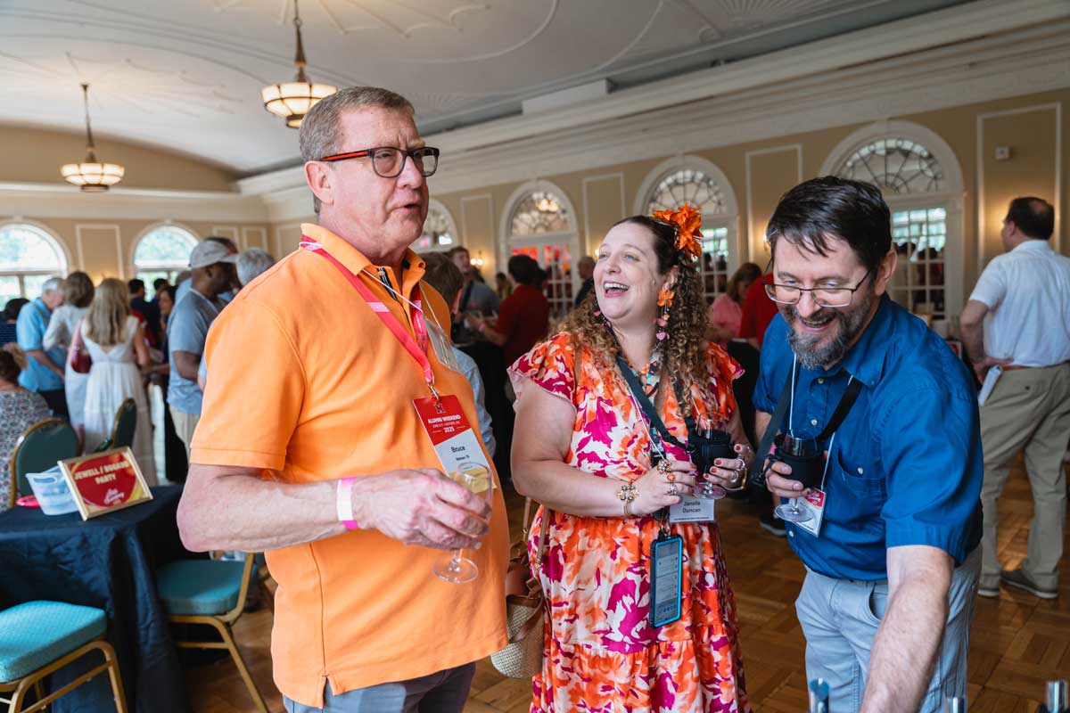 Miami University alumni chatting and enjoying drinks at a wine tasting event in the Oxford Community Arts Center.