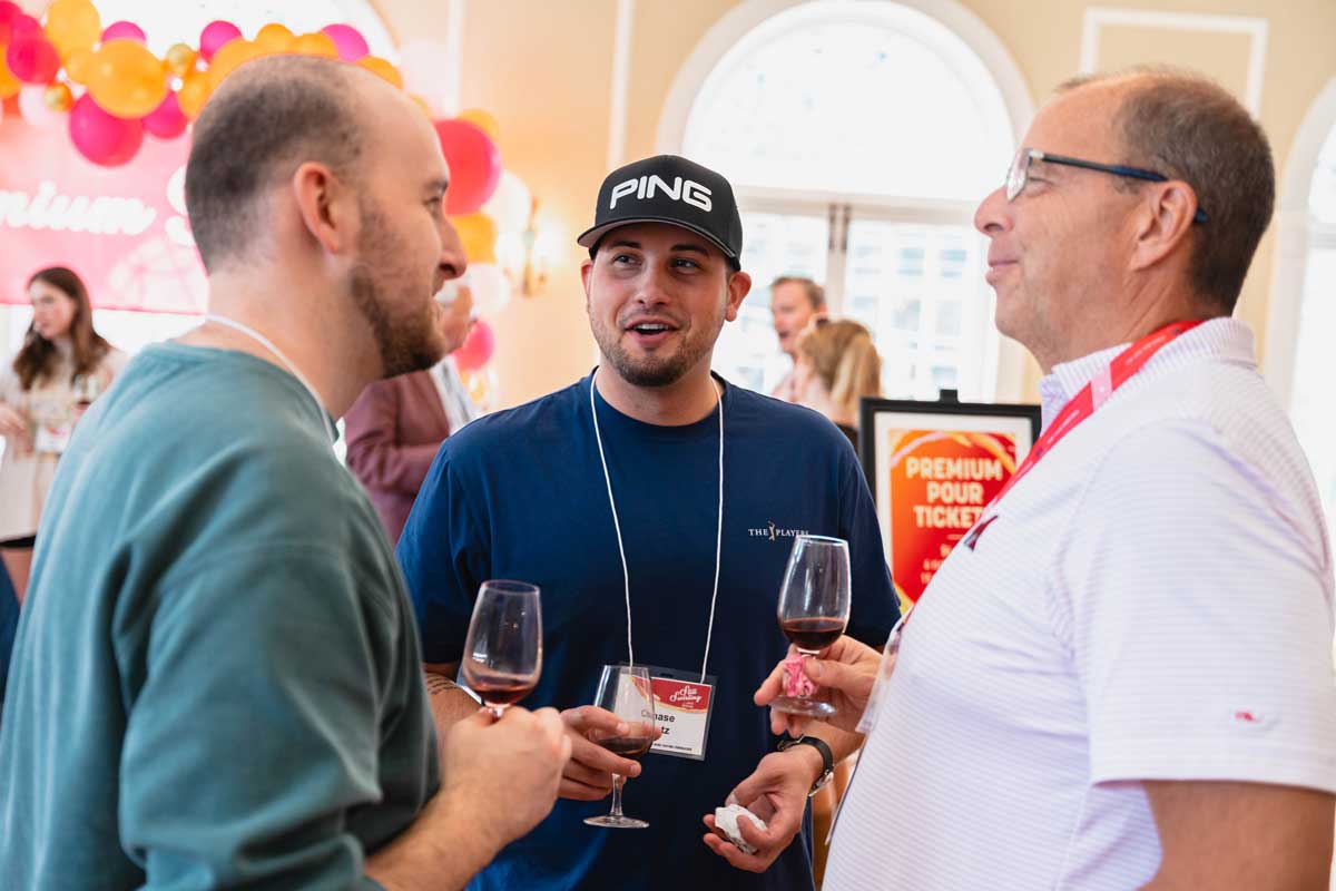 Miami University alumni networking and sharing wine at a wine tasting event in the Oxford Community Arts Center.