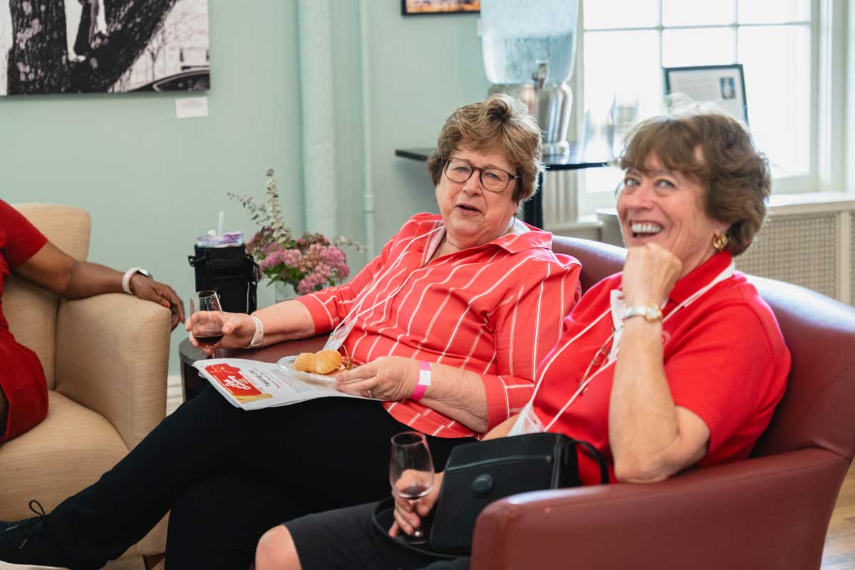 Miami University alumni relaxing and enjoying wine at a wine tasting event in the Oxford Community Arts Center.