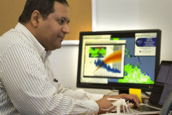 Dr. Rao showing mosquito model on computer screen