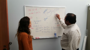 A student works with Dr. Rao on a whiteboard