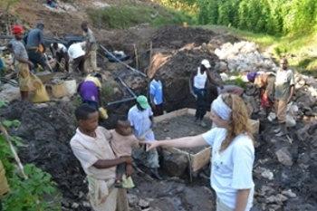 Katie and local workers construct spring box water purification system