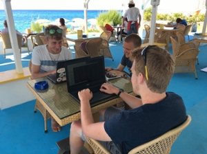 Students programming on the beach