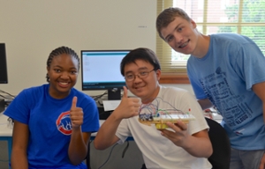Summer Scholars group gives a thumbs-up with their robot