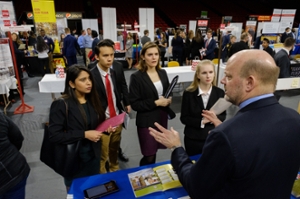 Several students listen to one employer