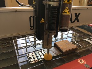 A CNC machine cutting out the metal for the door openers