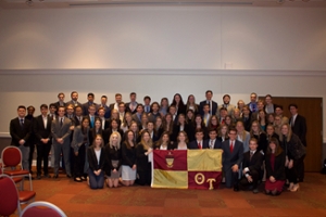 All members of Theta Tau take a picture with the Theta Tau flag in front