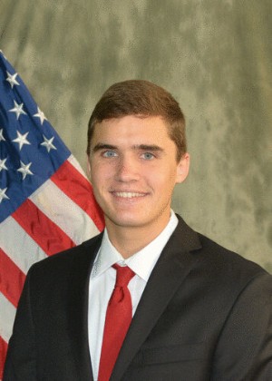Headshot of Nick Hagerty in front of an American flag
