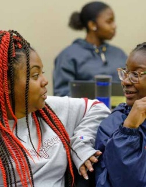 Keisha Norris and student Eunice talking with each other