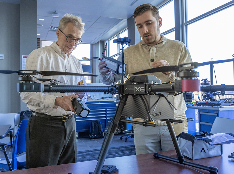 student working on a drone