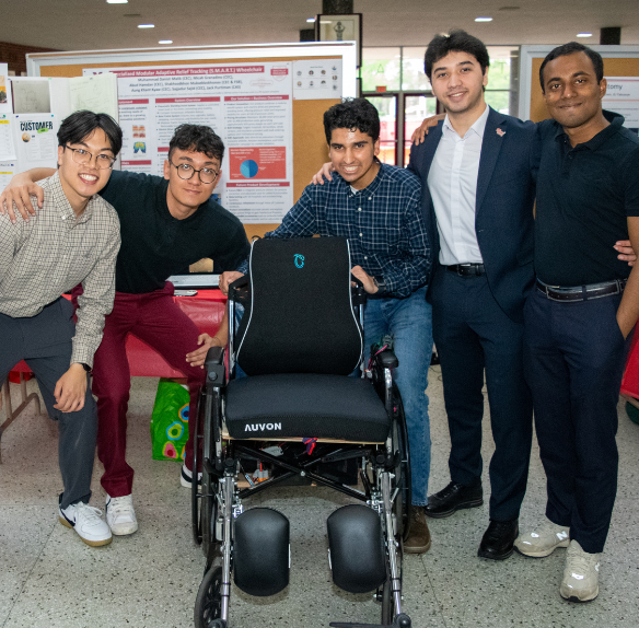 Enginering students at 2025 Senior Design Expo with smart wheelchair project