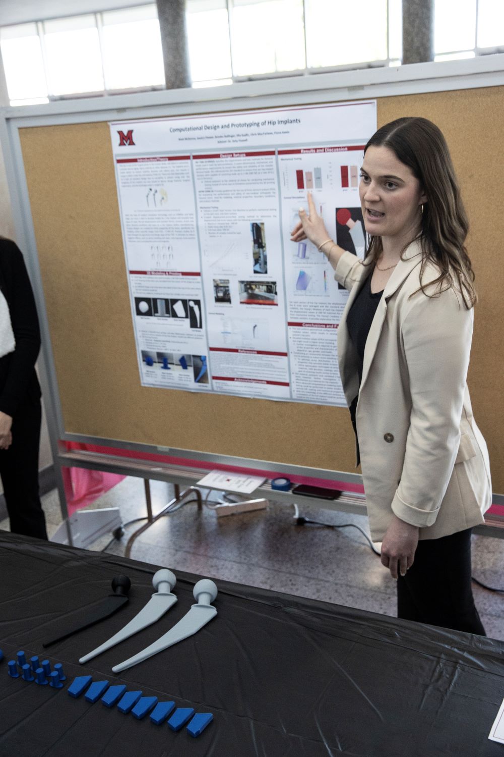 Female presenting at a poster session