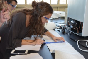 paper science student measuring in a paper laboratory