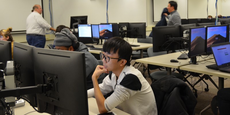 student sitting in computer lab working on a project