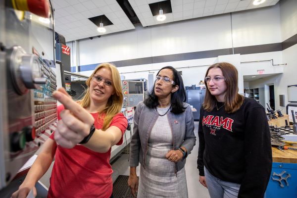 Two female MME students working in a lab with Dean Sukumaran