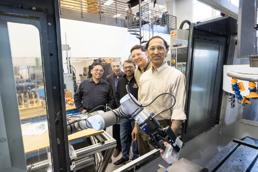 mechanical engineering professors working in lab with machinery