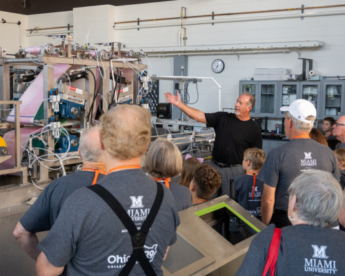 Doug Hart demonstrates the functionality of the Pilot Paper Machine to an assembly of grandparents and their grandchildren at Miami CEC.