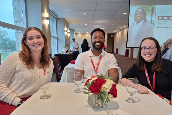 Lauren Devney sits at luncheon table with CEC alumna Nora Winnestaffer and CAS alumnus Aharon Brown.
