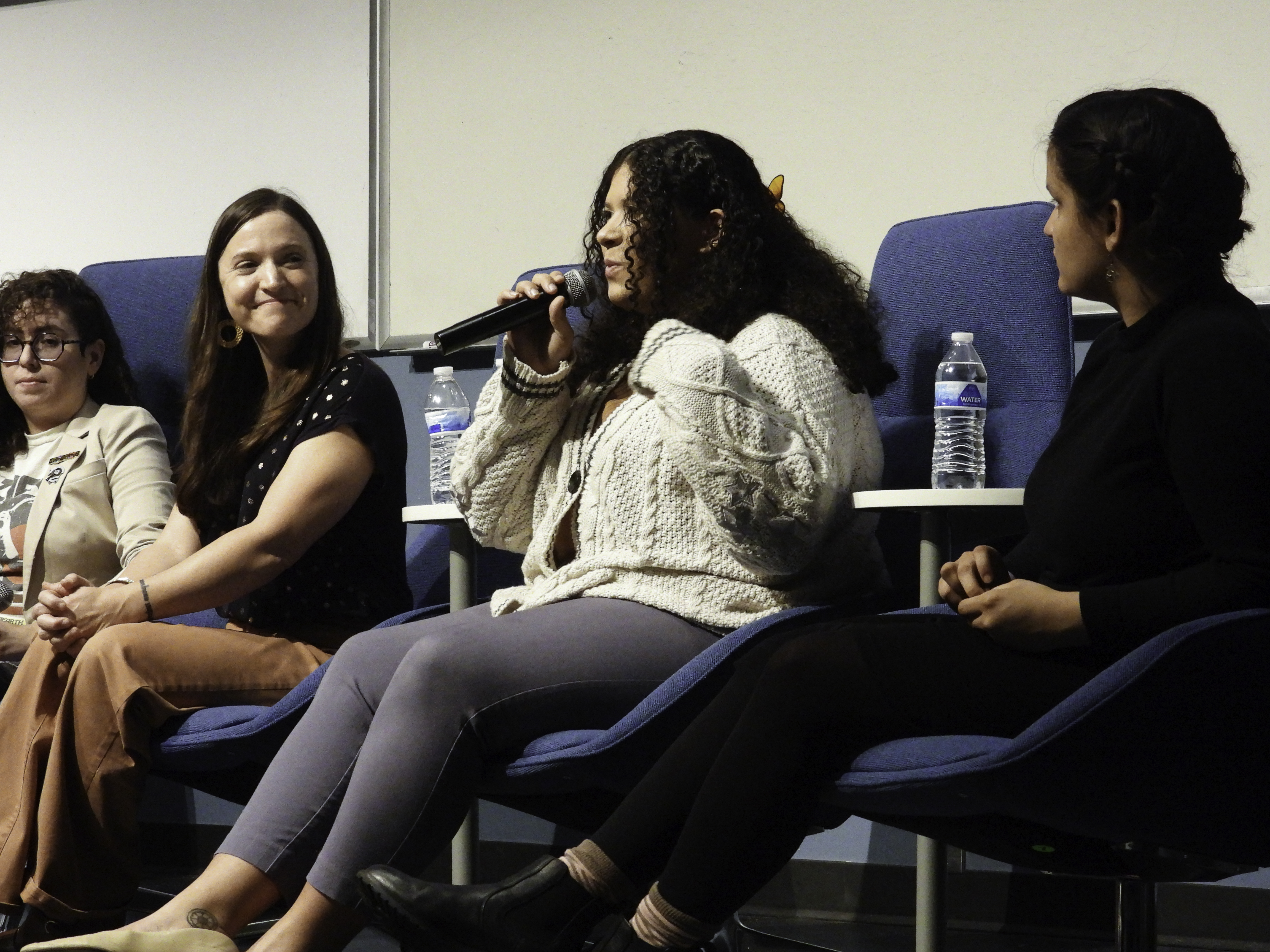 Panelist Cyan Perez speaks into the microphone.