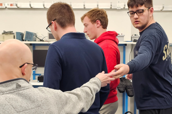 HYPE student members work on computers in lab space