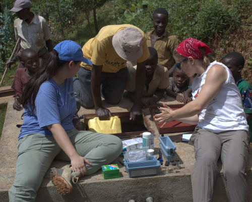 Two female CEC students from Oxford, Ohio work with local professional engineers and community members to install a water rehabilitation system in the Rugendabari sector of Rwanda.