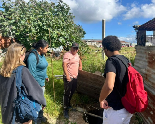Miami students working on a project in Guatemala, looking at a well