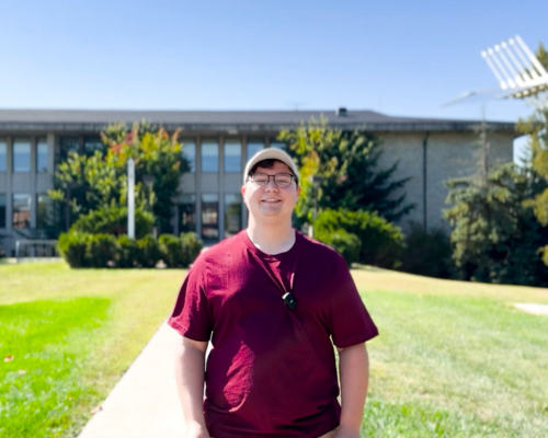Cameron Paul in front of Hoyt Hall