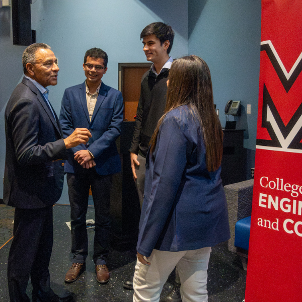 Students speak to Paliwal after the event.