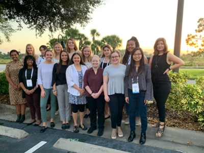 Dr. Karen Davis standing outside on a sunny day with 15 other women posing for a picture at the Grace Hopper Celebration of Women in Computing.