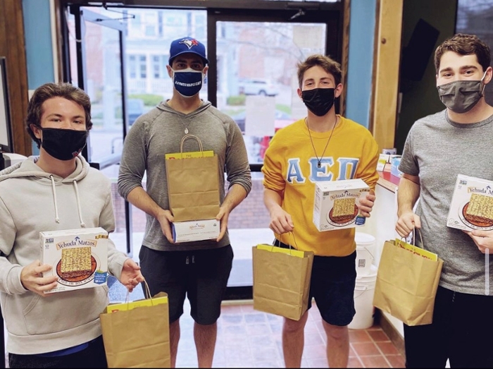 Matthew Stephan with AEPi members holding bags.