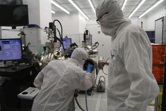 Trevor Karnehm in the clean room lab with students.