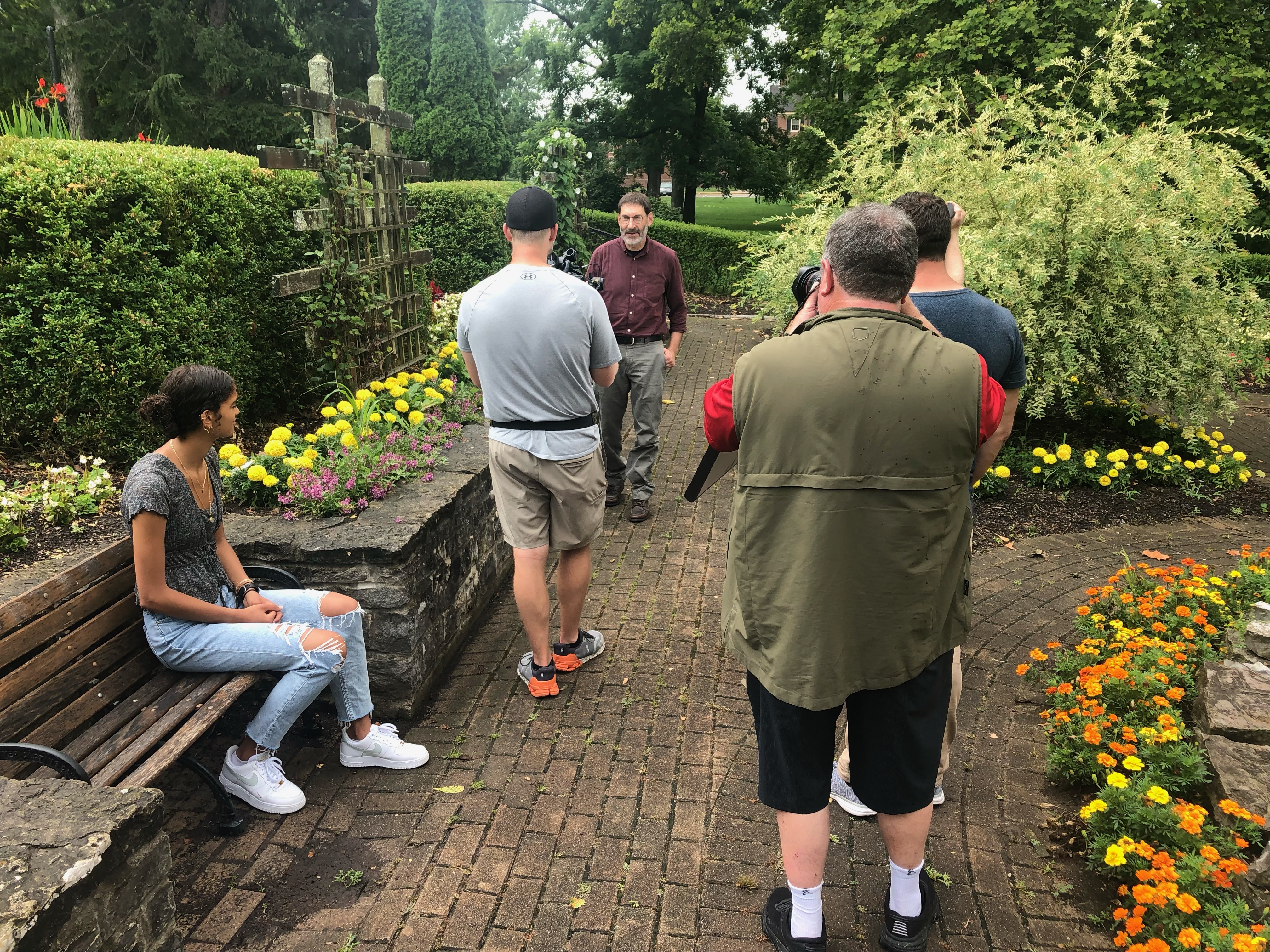 Staff and students producing footage for the college tour video in an outdoor location.