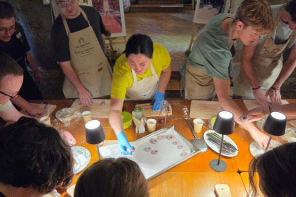 CEC students place hand rolled dough on a pan in Italy 