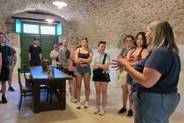 Miami students listen to a guide in an underground cellar in Italy