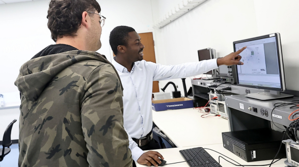 professor showing a student something on a computer screen