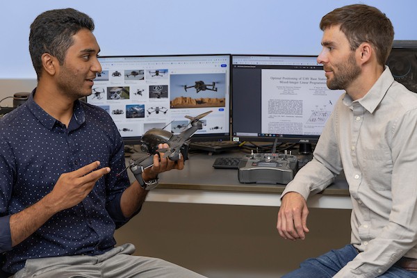 Raj  Gowtham and Brian Van Scoy talking in the AI Lab.