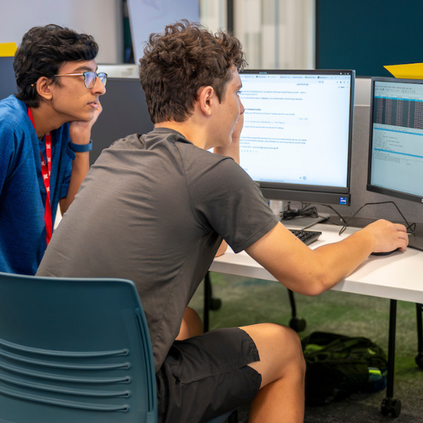 Two students work on a computer in the Cybersecurity lab