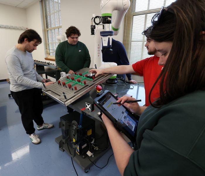 Engineering students working on the tic-tac-toe robotics project