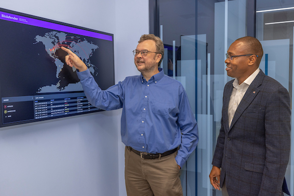James Walden and Joseph Nwankpa review the dynamic global cyber threat map in the McVey Data Science building.