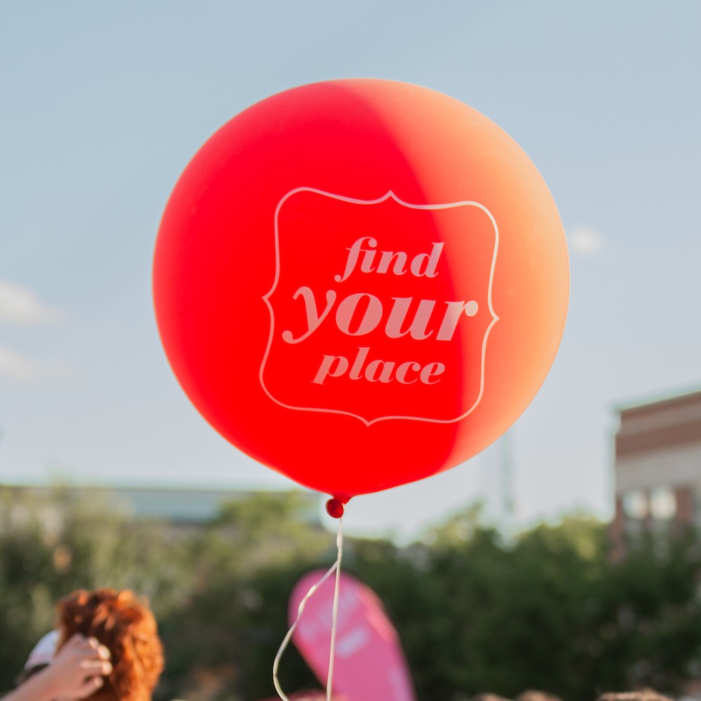 Ballon floating in the air with the message: Find your place