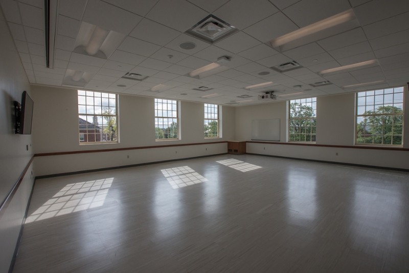 ASC 2084, an empty room with white walls and windows providing natural light.