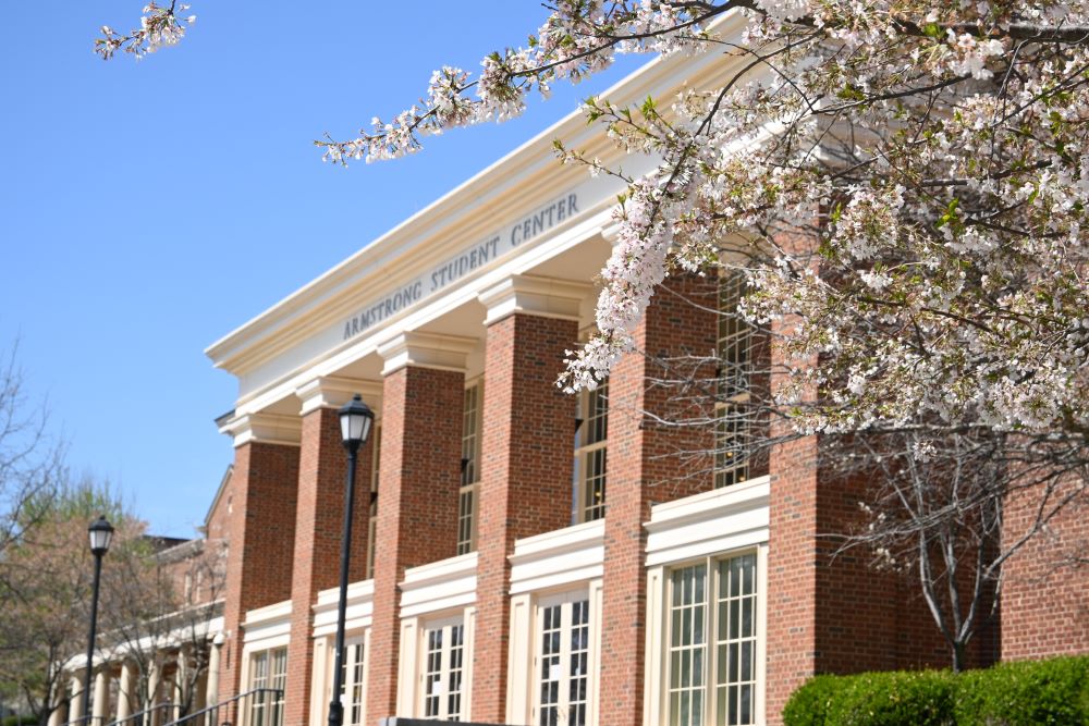 Exterior of the Armstrong Student Center with Cherry Blossom blooms