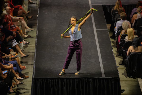 female student on a runway during a fashion show